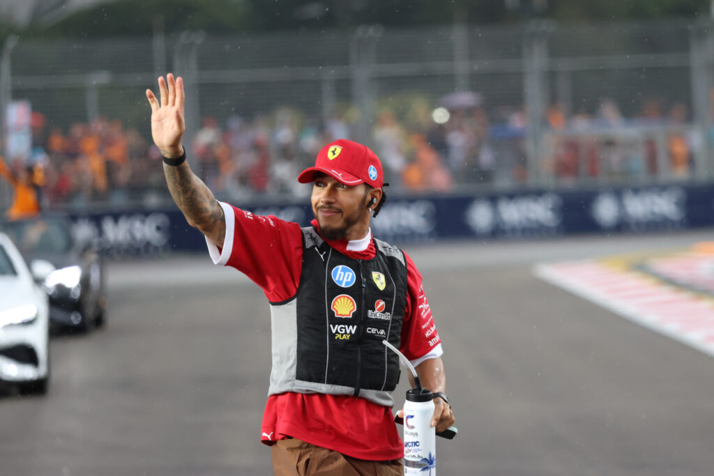 Ferrari driver Lewis Hamilton waving to the crowd at the 2025 Formula 1 Singapore Grand Prix