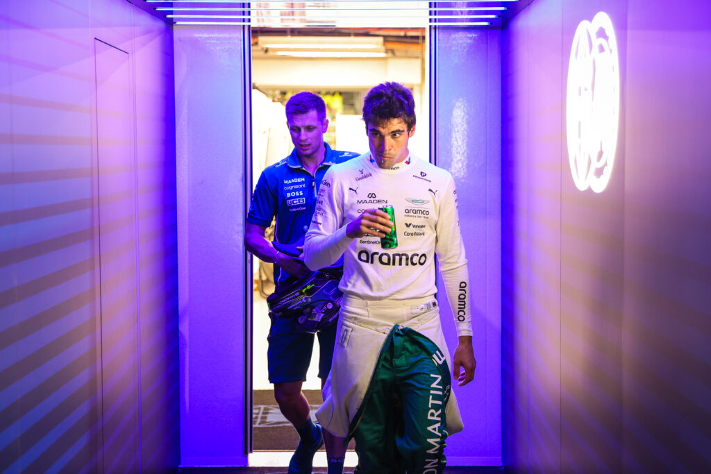 Aston Martin driver Lance Stroll walking through the garage at the 2025 Formula 1 Singapore Grand Prix