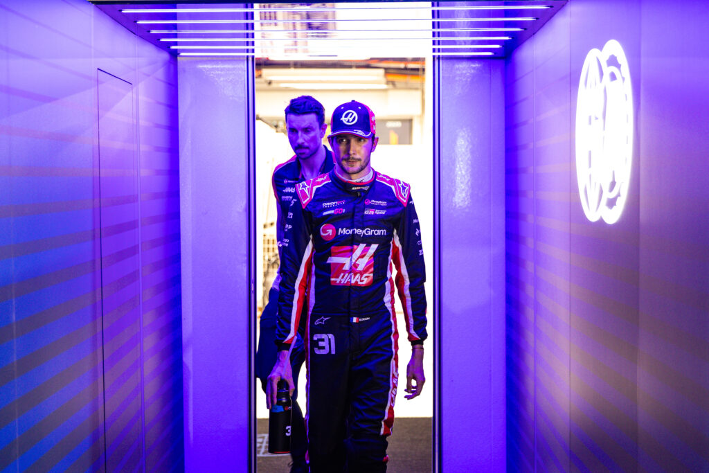 Haas driver Esteban Ocon walking through the garage at the 2025 Formula 1 Singapore Grand Prix