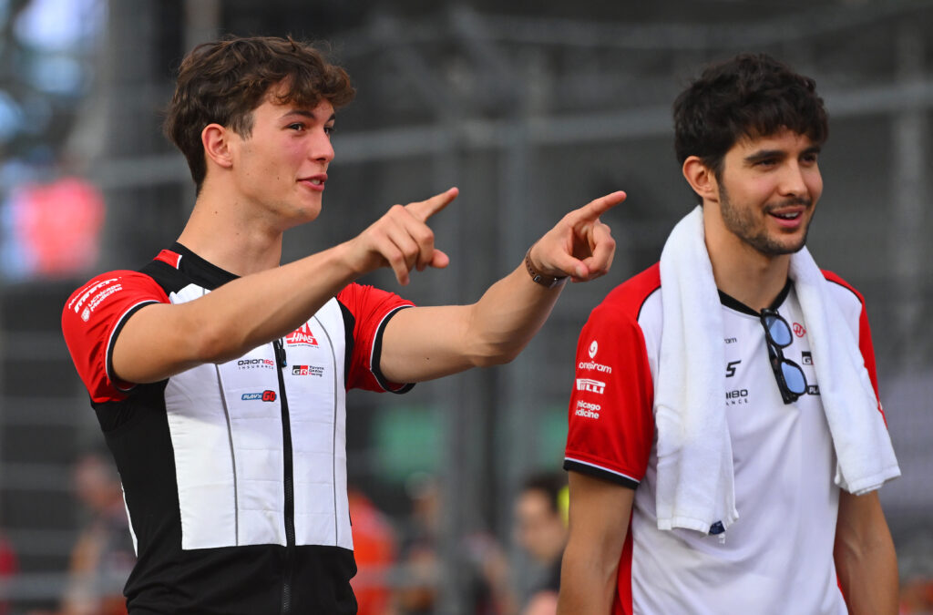 Haas' Oliver Bearman and Esteban Ocon speak during the drivers' parade before the 2025 F1 Singapore Grand Prix