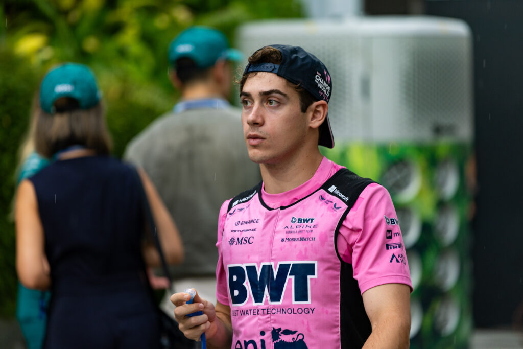 Alpine driver Franco Colapinto walking through the paddock at the 2025 Formula 1 Singapore Grand Prix