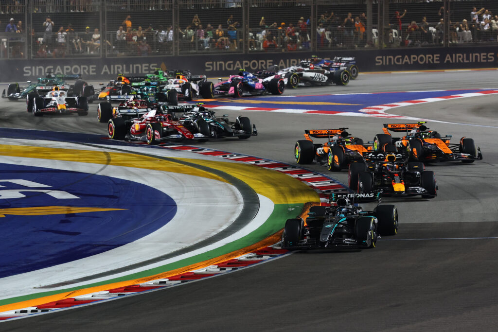 Lando Norris overtakes his McLaren teammate Oscar Piastri at the start of the 2025 F1 Singapore Grand Prix