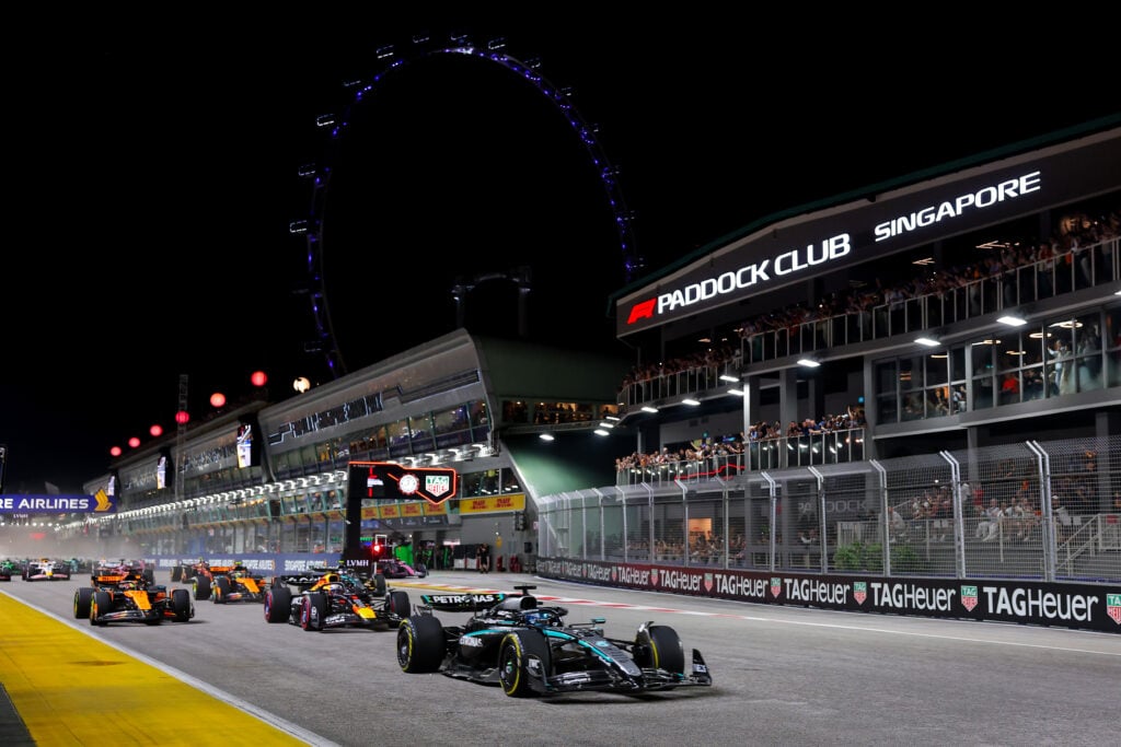 Mercedes driver George Russell leads Red Bull's Max Verstappen at the start of the 2025 F1 Singapore Grand Prix