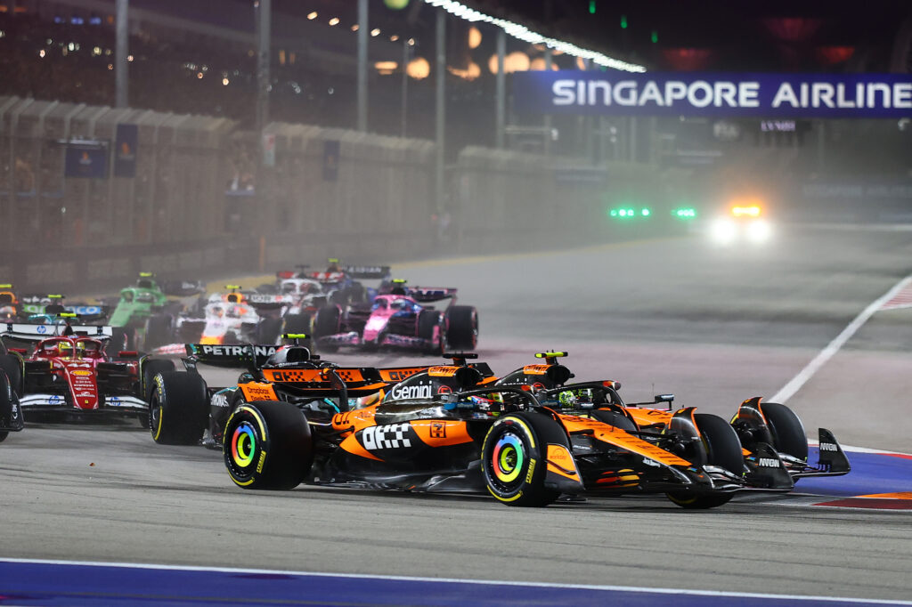 Oscar Piastri and Lando Norris of McLaren together going into turn one at the 2025 Singapore Grand Prix