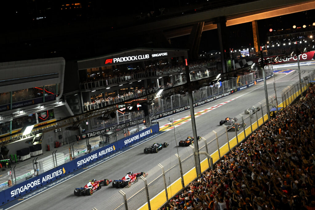 Charles Leclerc overtakes Ferrari teammate Lewis Hamilton off the grid in the 2025 F1 Singapore Grand Prix