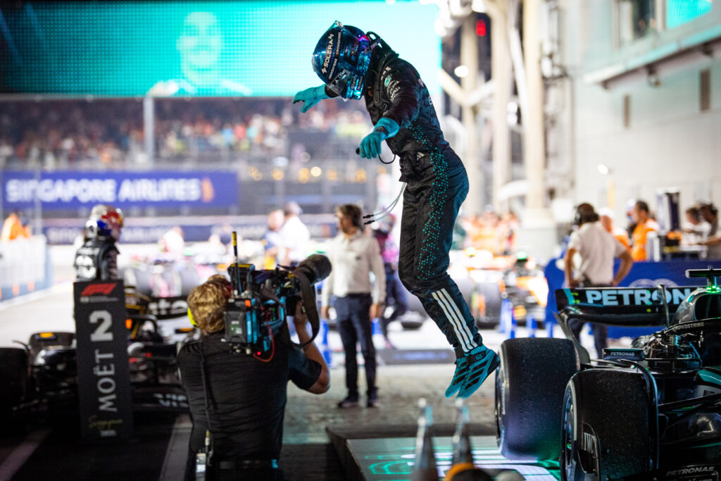 Mercedes driver George Russell jumping off his car after winning the 2025 Formula 1 Singapore Grand Prix