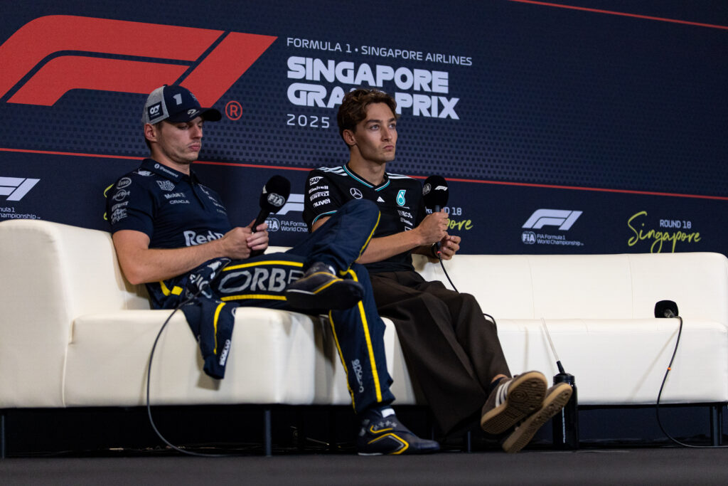 Max Verstappen and George Russell sat in the press conference room after the 2025 Singapore Grand Prix.