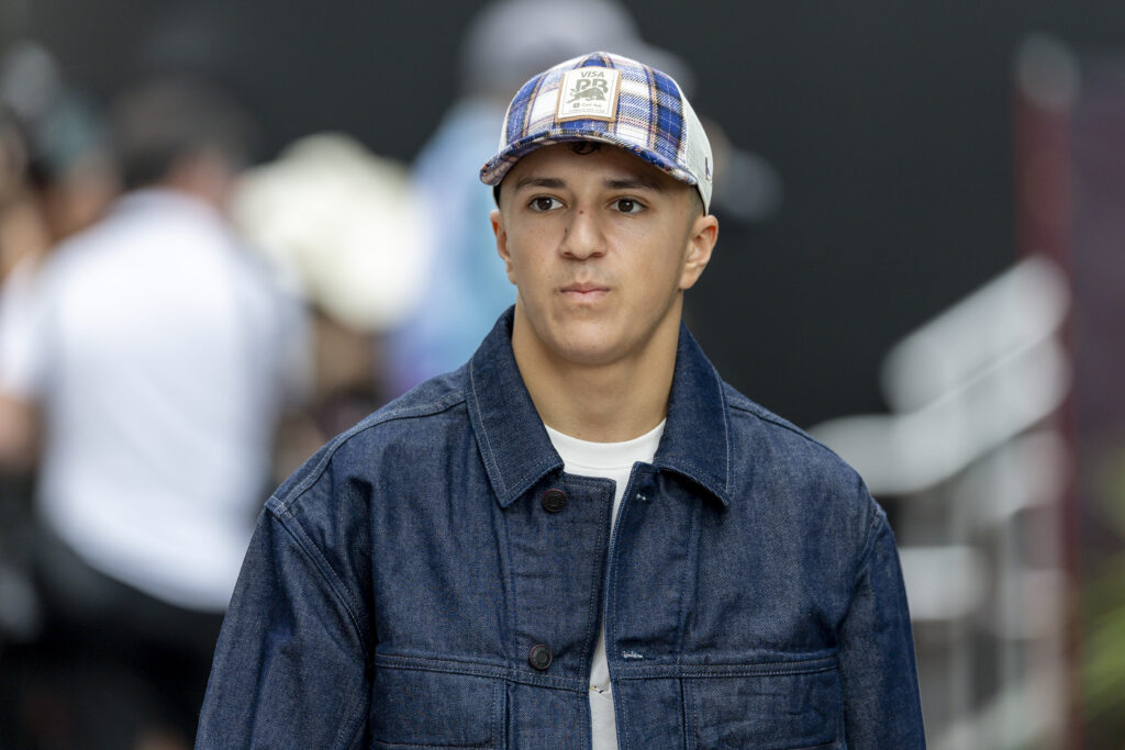 Isack Hadjar of Racing Bulls walks in the United States Grand Prix paddock