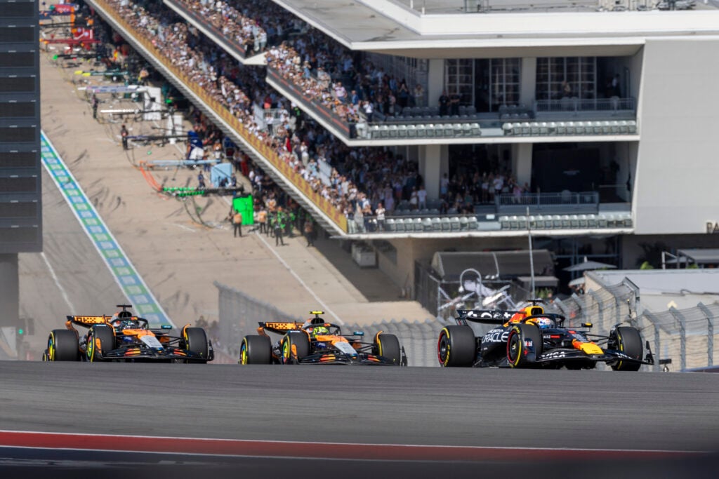 Red Bull's Max Verstappen leads McLaren's Lando Norris and Oscar Piastri at the start of COTA Sprint at the 2025 F1 United States Grand Prix