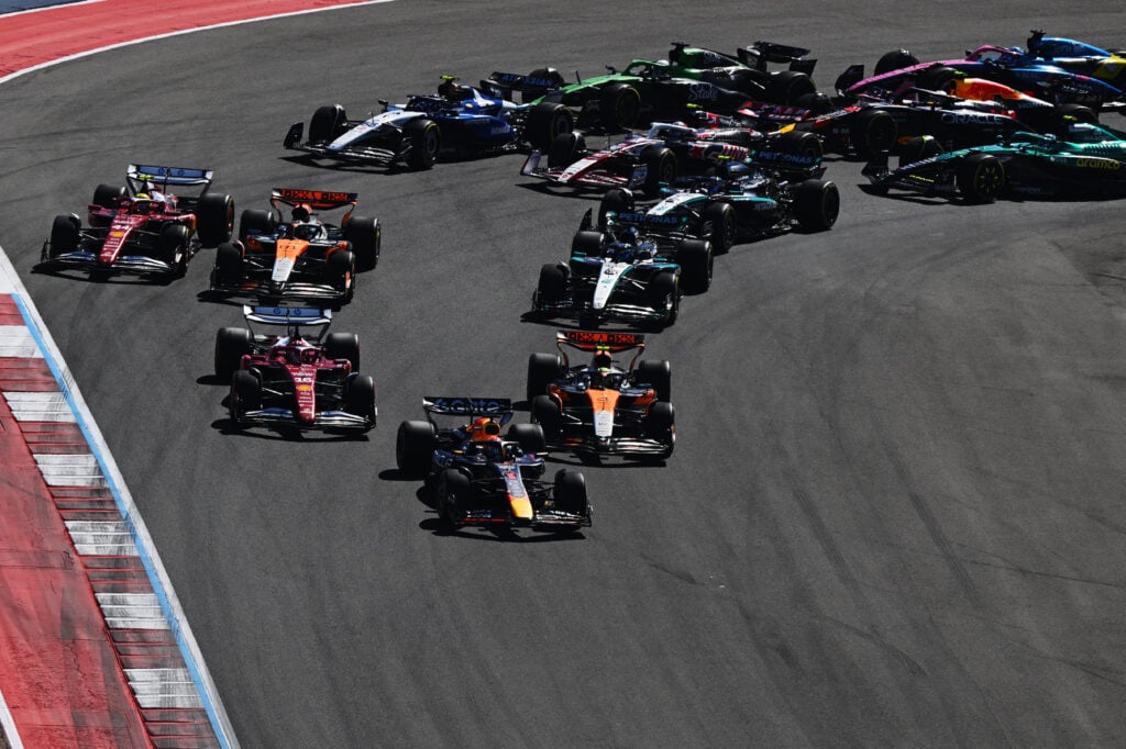Ferrari driver Lewis Hamilton going around the outside of McLaren driver Oscar Piastri at the start of the 2025 Formula 1 United States Grand Prix
