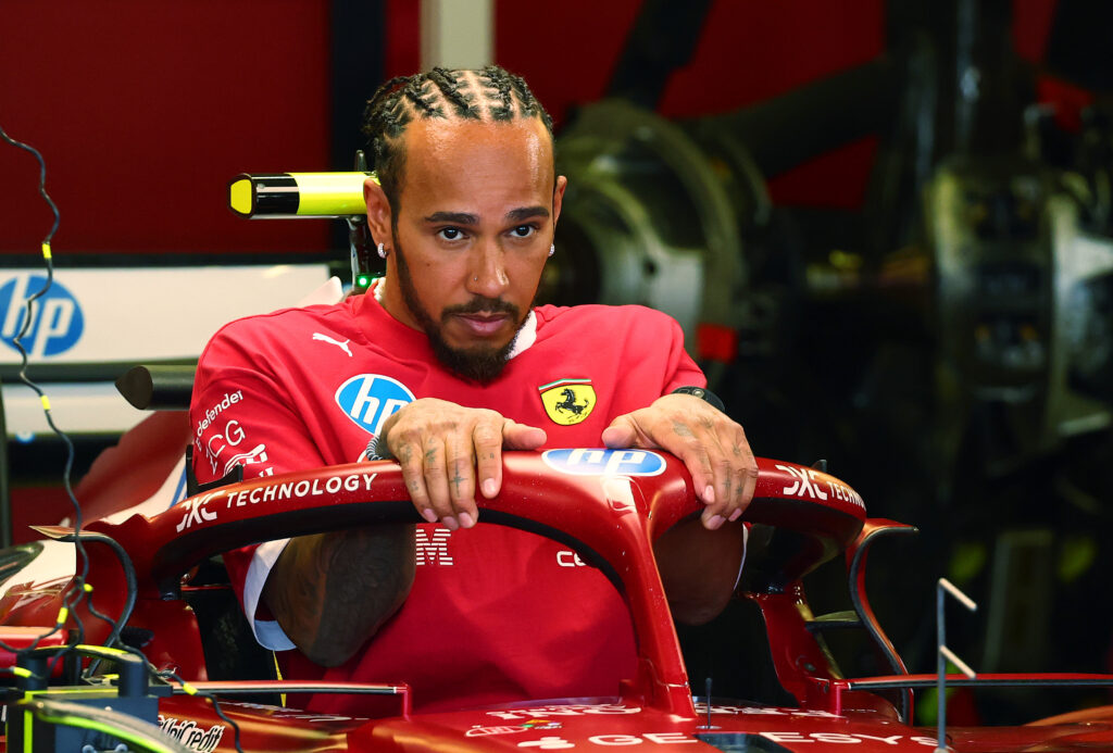 Lewis Hamilton of Ferrari gets into his car in the garage at the 2025 Mexico City Grand Prix