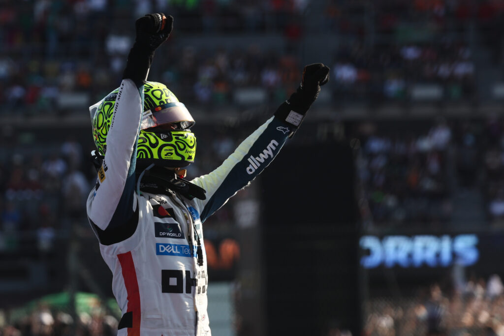 McLaren driver Lando Norris lifting his arms in the air after winning the 2025 Formula 1 Mexico City Grand Prix