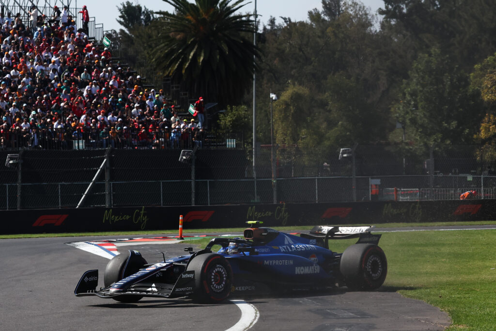 Williams driver Carlos Sainz driving across the grass at the 2025 Formula 1 Mexico City Grand Prix