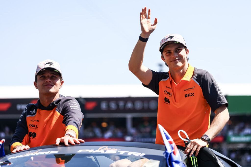 McLaren's Oscar Piastri waves to fans with Lando Norris during the drivers' parade before the 2025 F1 Mexico City Grand Prix