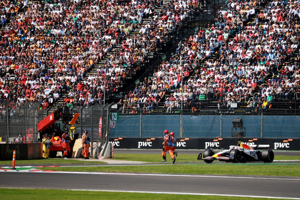 Racing Bulls driver Liam Lawson avoiding a marshal on the track at the 2025 Formula 1 Mexico City Grand Prix
