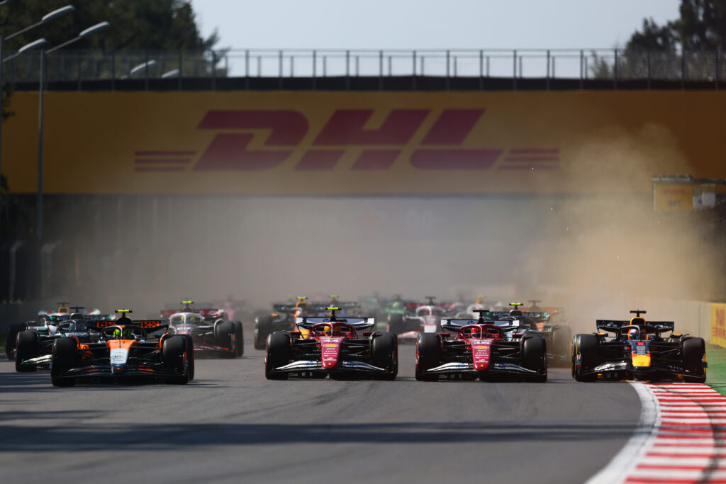 Lando Norris, Charles Leclerc, Lewis Hamilton and Max Verstappen approaching the first corner of the 2025 Formula 1 Mexico City Grand Prix