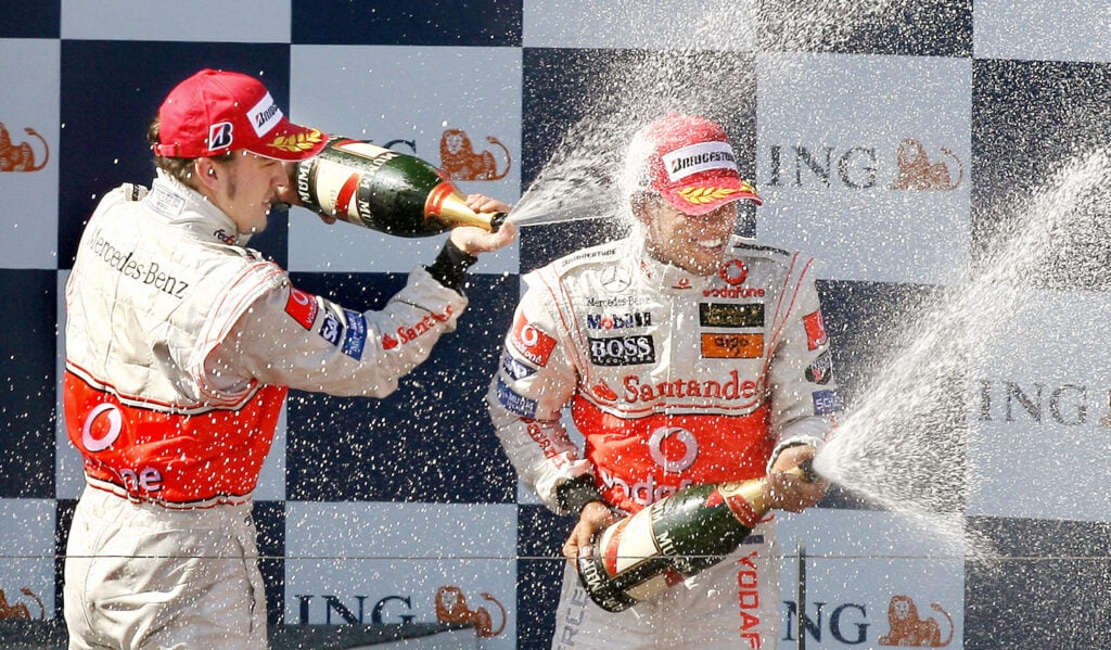McLaren driver Fernando Alonso spraying champagne on teammate Lewis Hamilton at the 2007 Formula 1 Australian Grand Prix