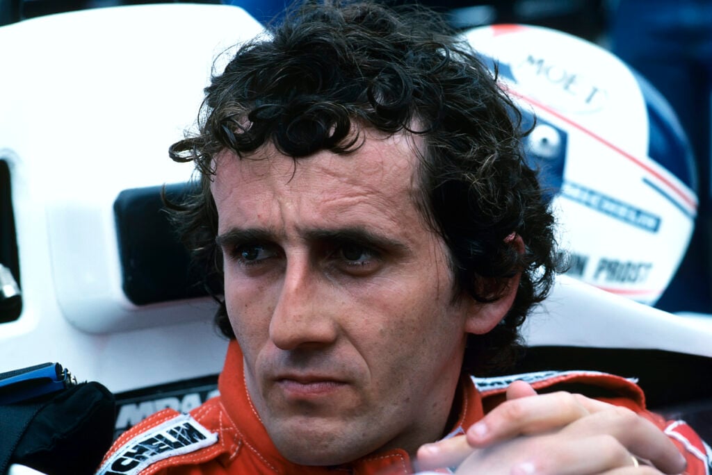 McLaren driver Alain Prost sits in his car before the 1984 Grand Prix of Detroit