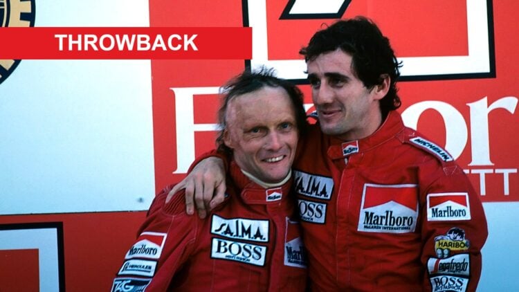 Niki Lauda and Alain Prost on the podium at the 1984 Portuguese Grand Prix, with a Throwback banner
