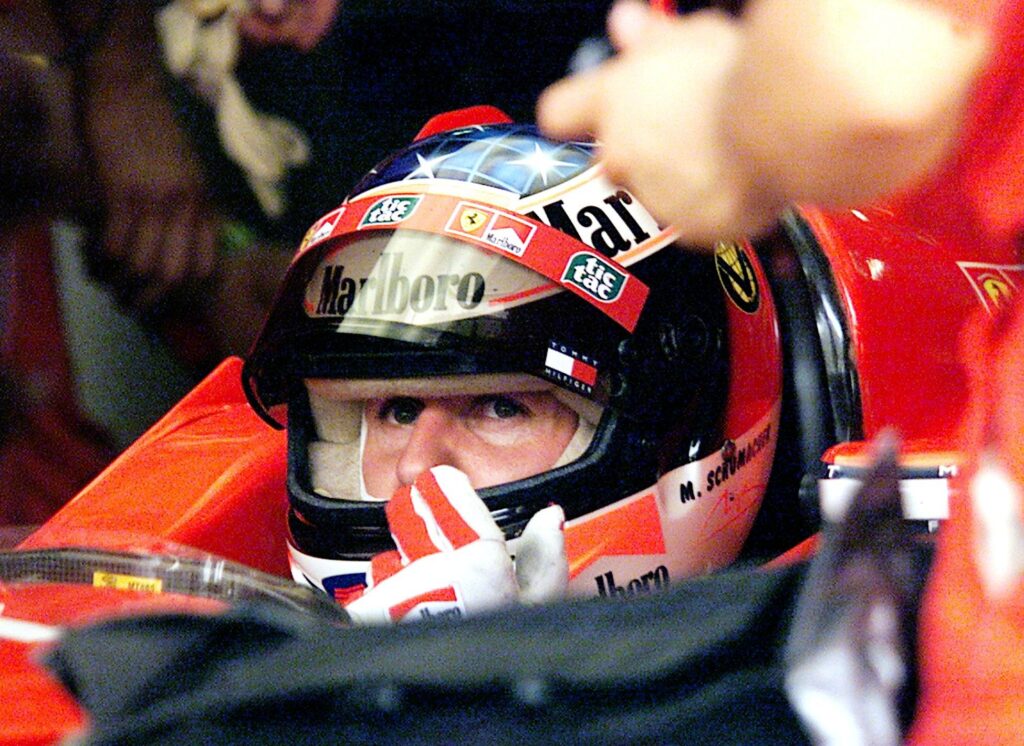 Ferrari driver Michael Schumacher sitting in his car at the 1999 Malaysian Grand Prix