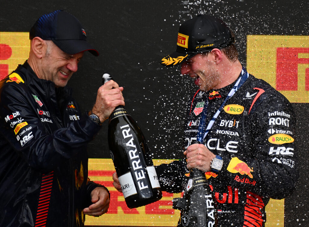 Adrian Newey and Max Verstappen celebrating on the podium at the 2023 Formula 1 Canadian Grand Prix