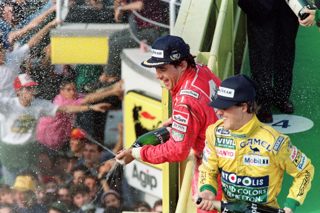 Ayrton Senna and Michael Schumacher celebrating on the podium at the 1992 Formula 1 Italian Grand Prix