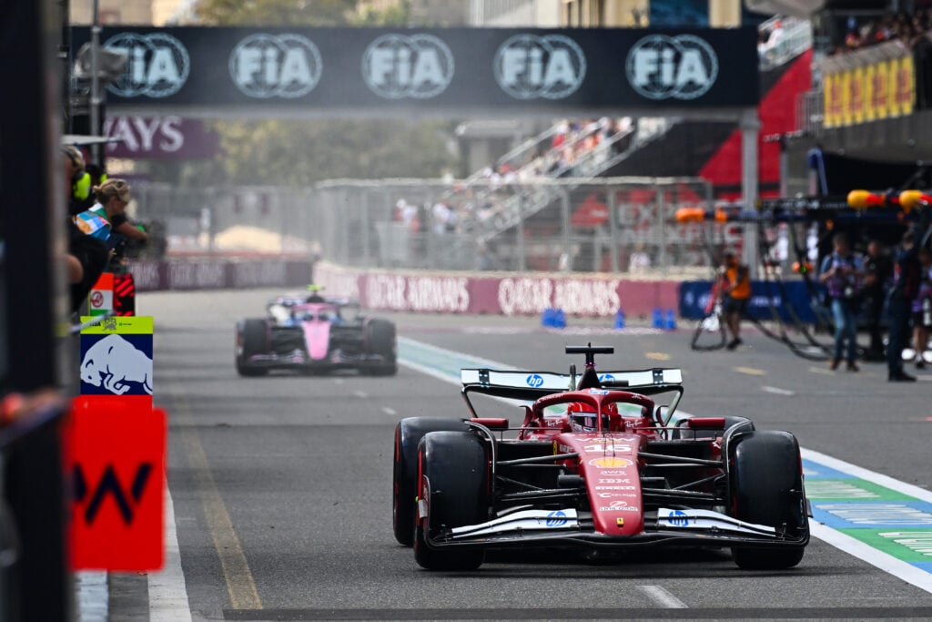 Ferrari's Charles Leclerc drives down the Baku pit lane ahead of Alpine's Franco Colapinto during practice for the 2025 F1 Azerbaijan Grand Prix