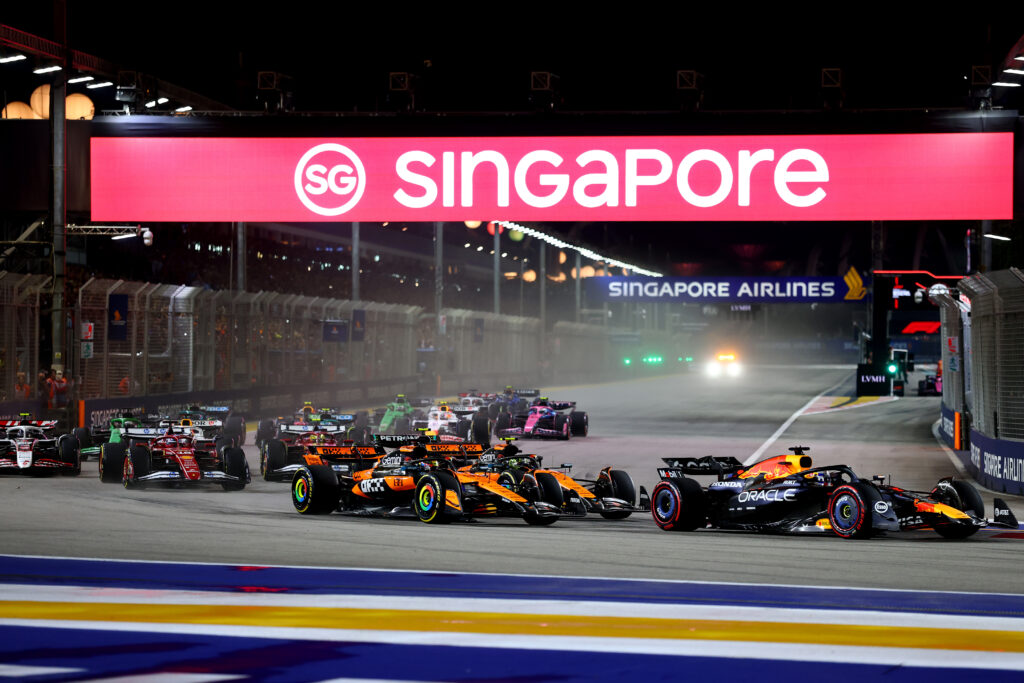 Red Bull's Max Verstappen leads the start of the 2025 F1 Singapore Grand Prix ahead of McLaren's Lando Norris and Oscar Piastri