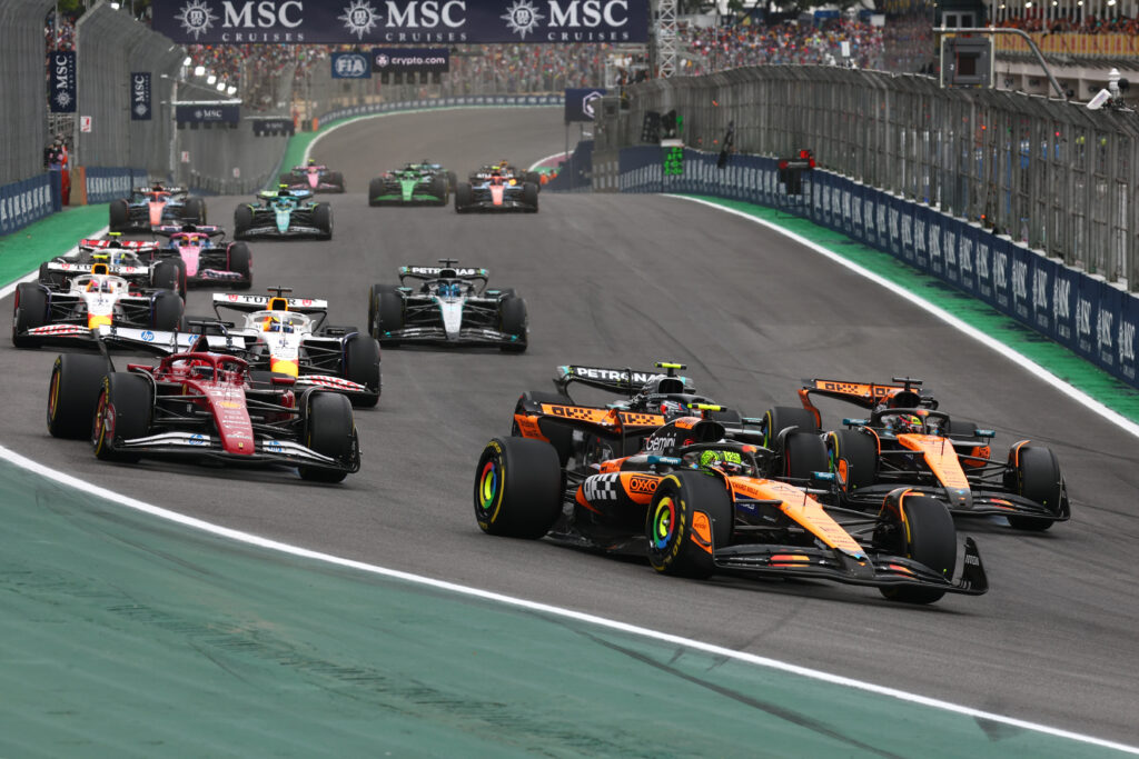 Ferrari's Charles Leclerc follows McLaren's Lando Norris on track at the start of the 2025 F1 Sao Paulo Grand Prix