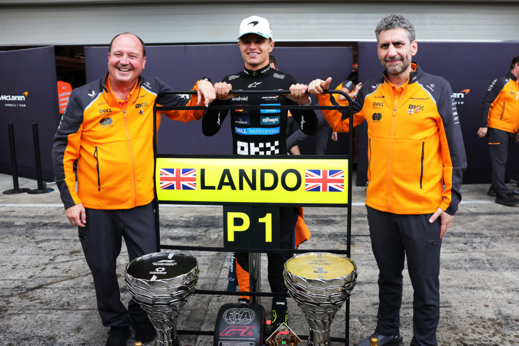 McLaren driver Lando Norris celebrates winning the 2025 F1 Sao Paulo Grand Prix with trackside commercial director Mark Norris and team principal Andrea Stella