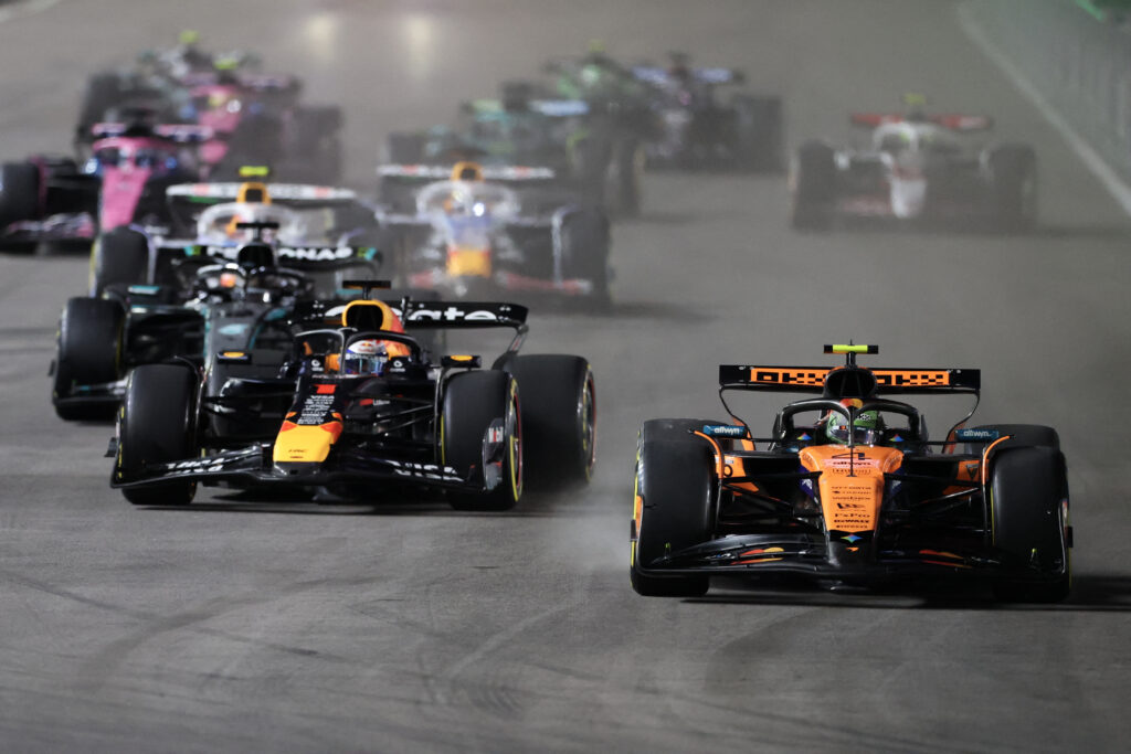 McLaren driver Lando Norris leading Red Bull driver Max Verstappen into the first corner at the 2025 Formula 1 Las Vegas Grand Prix