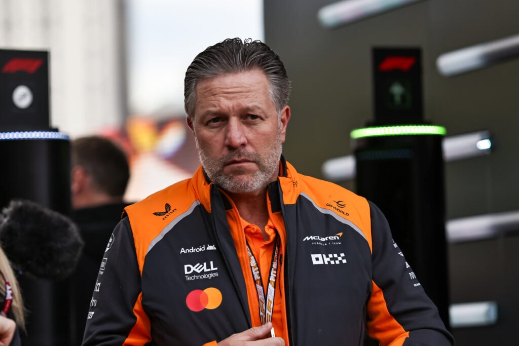 Zak Brown of McLaren arrives in the F1 paddock
