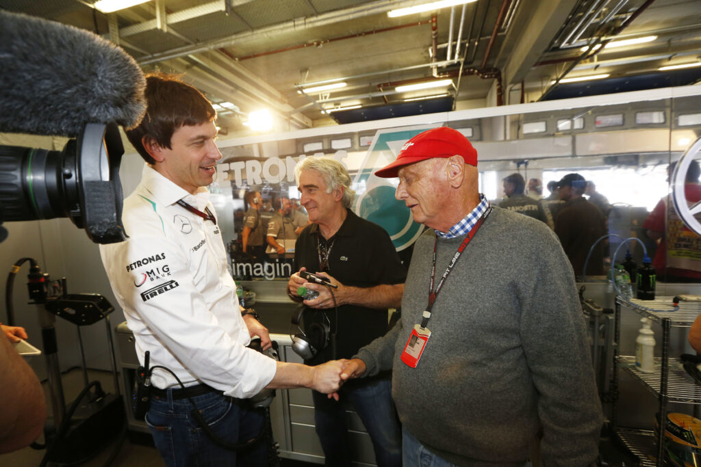Mercedes team principal Toto Wolff shaking Niki Lauda's hand at the 2013 Formula 1 German Grand Prix