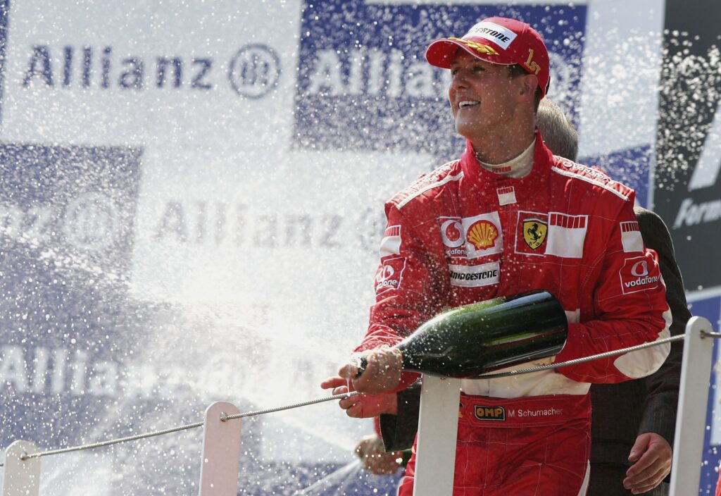 Michael Schumacher sprays champagne on the podium for the 2006 French Grand Prix