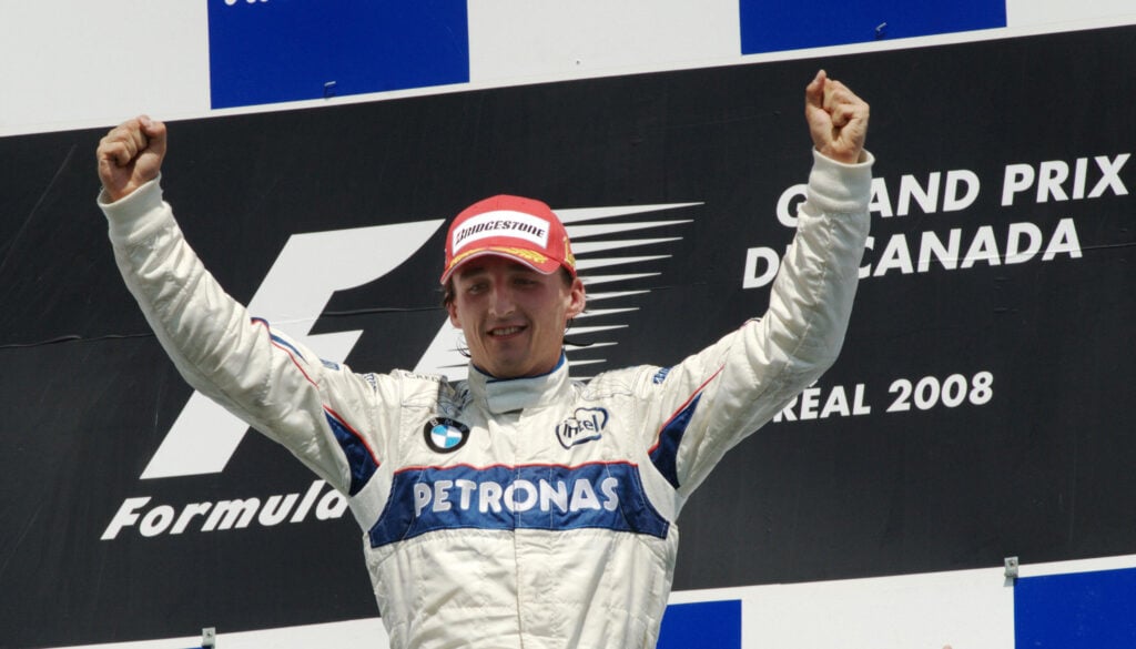 Robert Kubica celebrating on the podium after winning for BMW Sauber at the 2008 Canadian Grand Prix