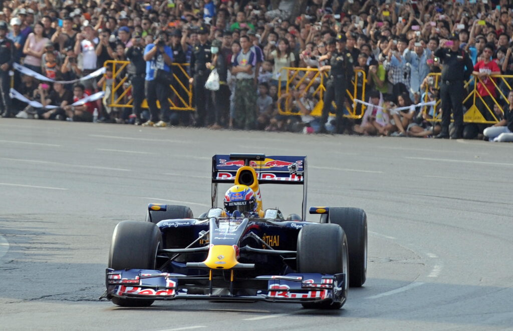 Formula One Red Bull driver Mark Webber driving in Bangkok, Thailand