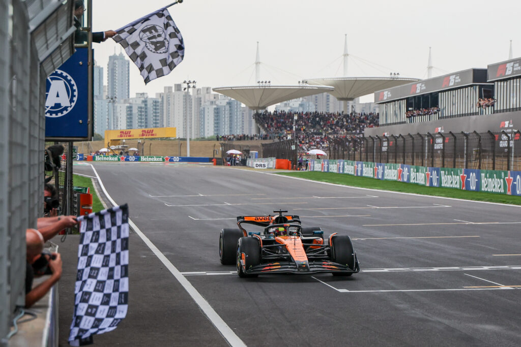 McLaren driver Oscar Piastri taking the chequered flag at the 2025 Formula 1 Chinese Grand Prix