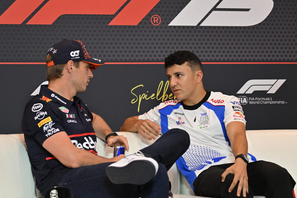 Red Bull driver Max Verstappen speaking to Racing Bulls driver Isack Hadjar in a press conference at the 2025 Formula 1 Austrian Grand Prix