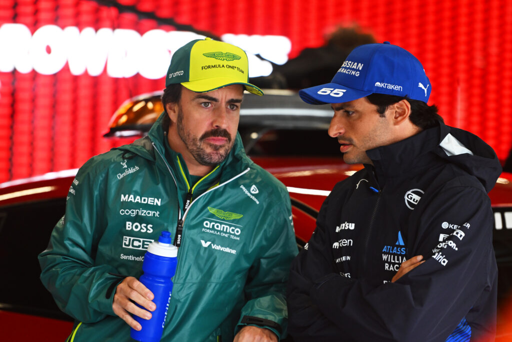 Aston Martin driver Fernando Alonso and Williams driver Carlos Sainz talking at the 2025 Formula 1 British Grand Prix