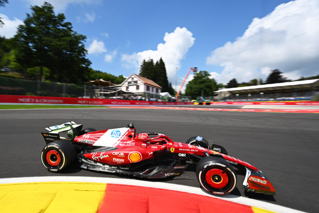 Charles Leclerc going through turn 1 in his Ferrari F1 car during FP1 at the 2025 Belgian Grand Prix.