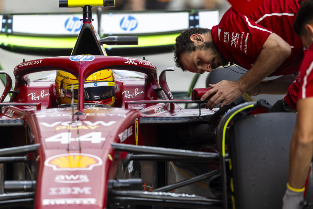 Ferrari driver Lewis Hamilton adjusts his mirror during practice at the 2025 F1 Hungarian Grand Prix