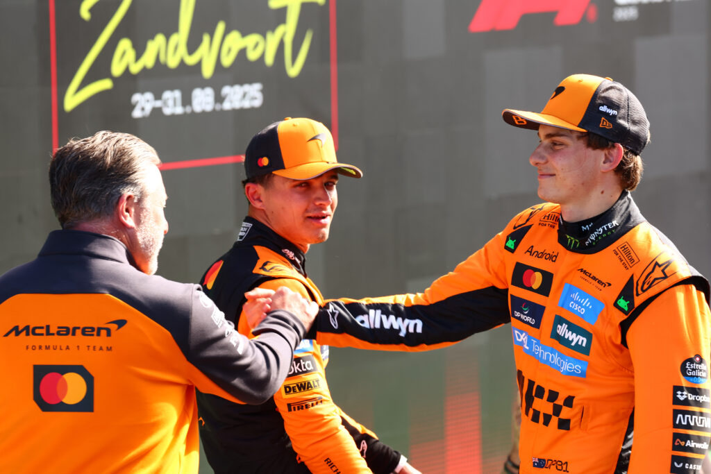 McLaren CEO Zak Brown congratulates Oscar Piastri on scoring pole for the 2025 F1 Dutch Grand Prix as Lando Norris looks on after qualifying