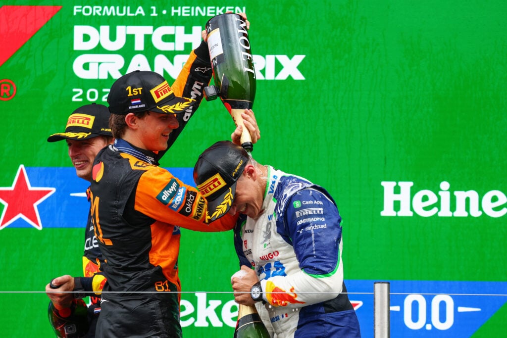 Oscar Piastri pouring champagne on Isack Hadjar at the 2025 Formula 1 Dutch Grand Prix