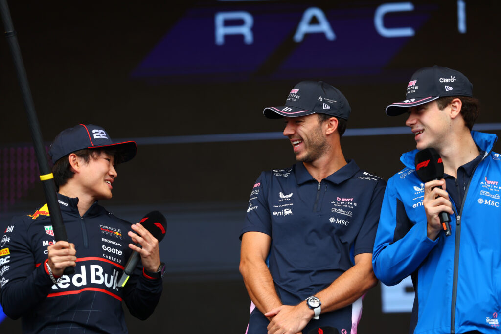 Red Bull driver Yuki Tsunoda on stage at the 2025 Formula 1 Azerbaijan Grand Prix with Alpine drivers Pierre Gasly and Franco Colapinto