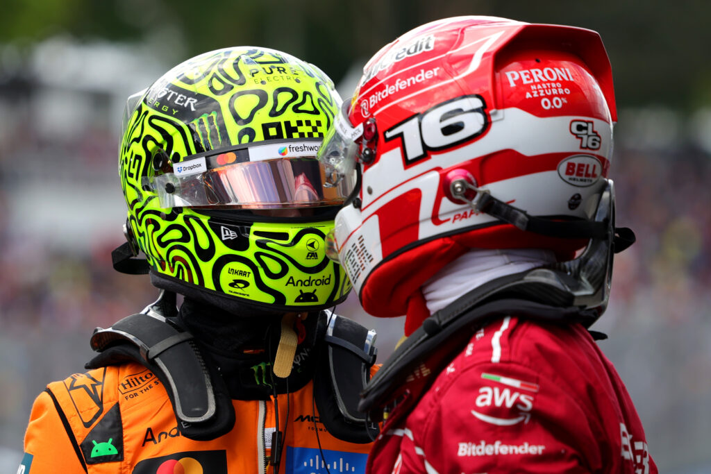 Lando Norris of McLaren speaks to Charles Leclerc of Ferrari in parc ferme