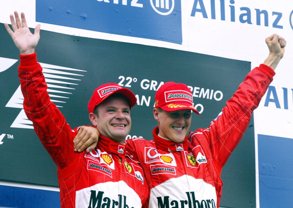 Rubens Barrichello and Michael Schumacher celebrating on the podium at the 2002 Formula 1 San Marino Grand Prix