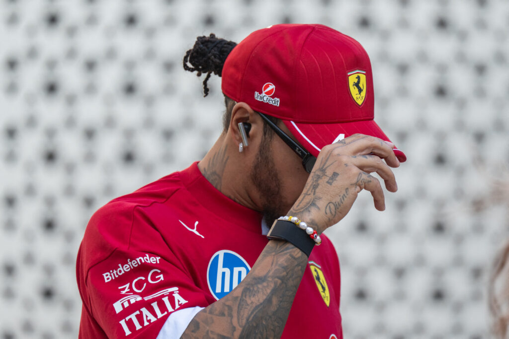 Ferrari driver Lewis Hamilton covering his face in the paddock at the 2025 Formula 1 Qatar Grand Prix