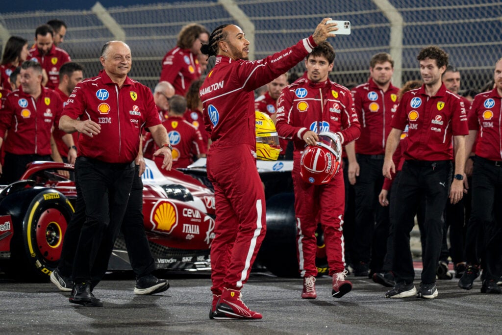 Lewis Hamilton, Fred Vasseur and Charles Leclerc pose for a photo on the grid at the 2025 F1 Abu Dhabi Grand Prix