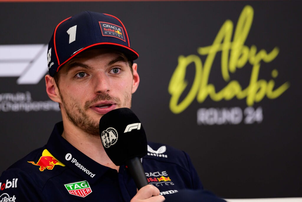 Red Bull driver Max Verstappen speaking into a microphone at the 2025 Formula 1 Abu Dhabi Grand Prix
