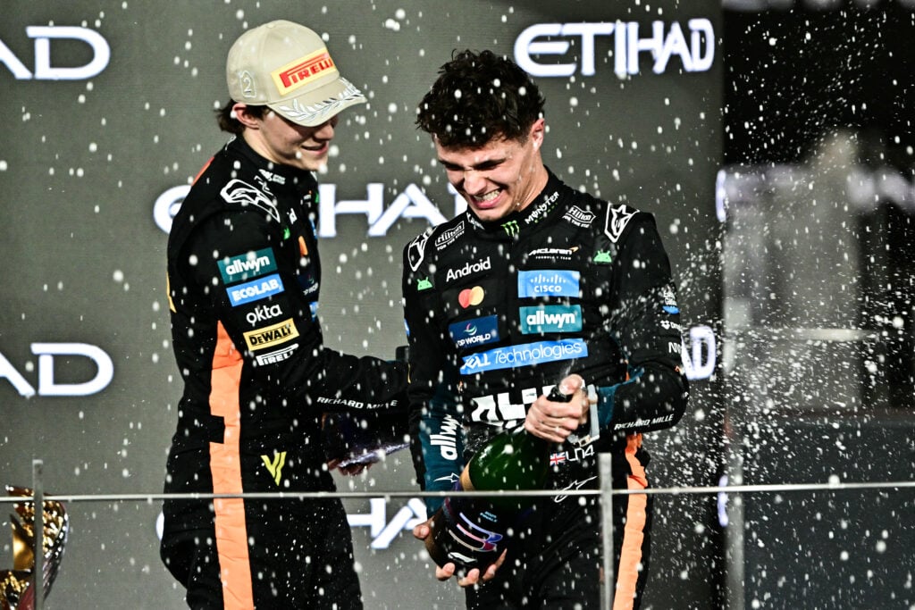 McLaren drivers Oscar Piastri and Lando Norris on the podium at the 2025 Formula 1 Abu Dhabi Grand Prix